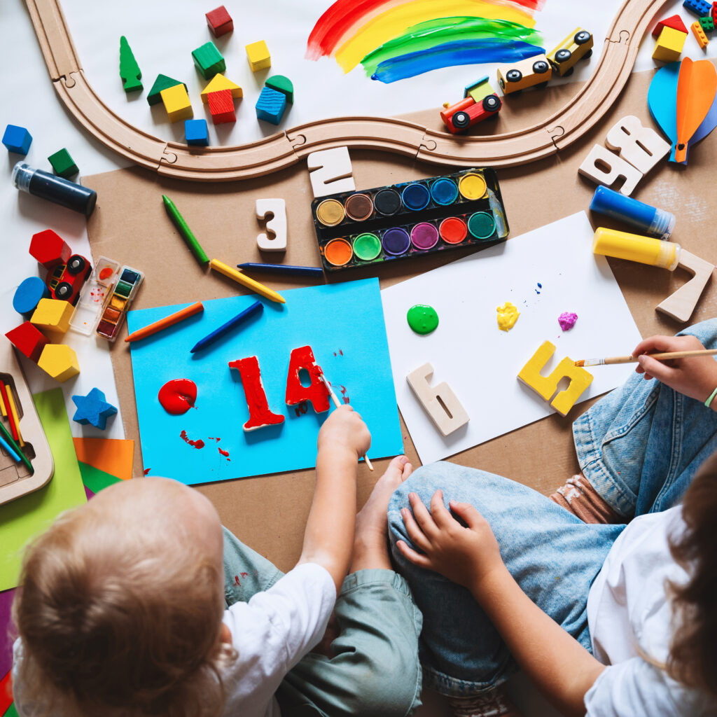 Children Drawing And Making Crafts In Kindergarten Or Daycare.