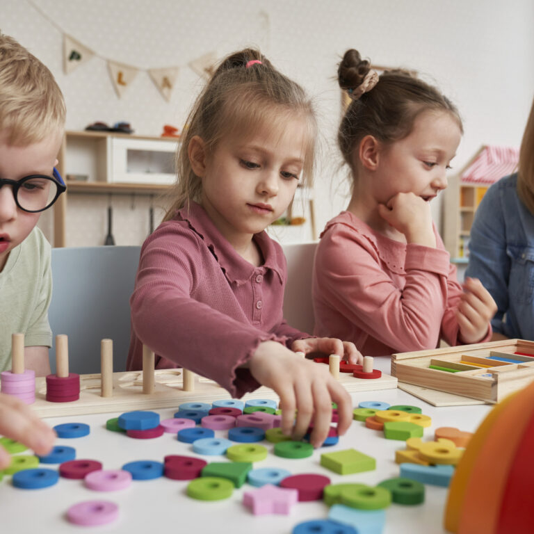 Teacher And Children Doing Sensory Exercises In The Kindergarten