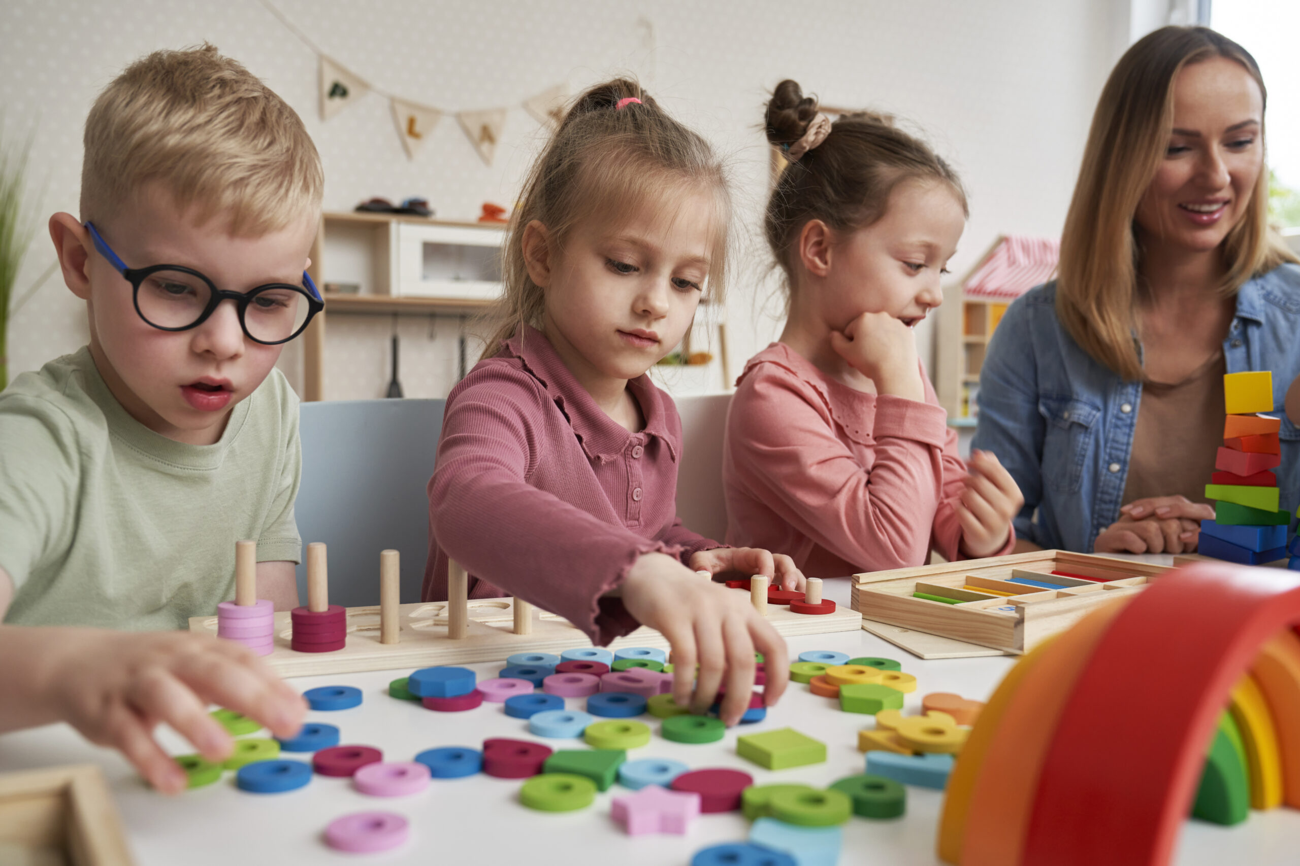 Teacher And Children Doing Sensory Exercises In The Kindergarten